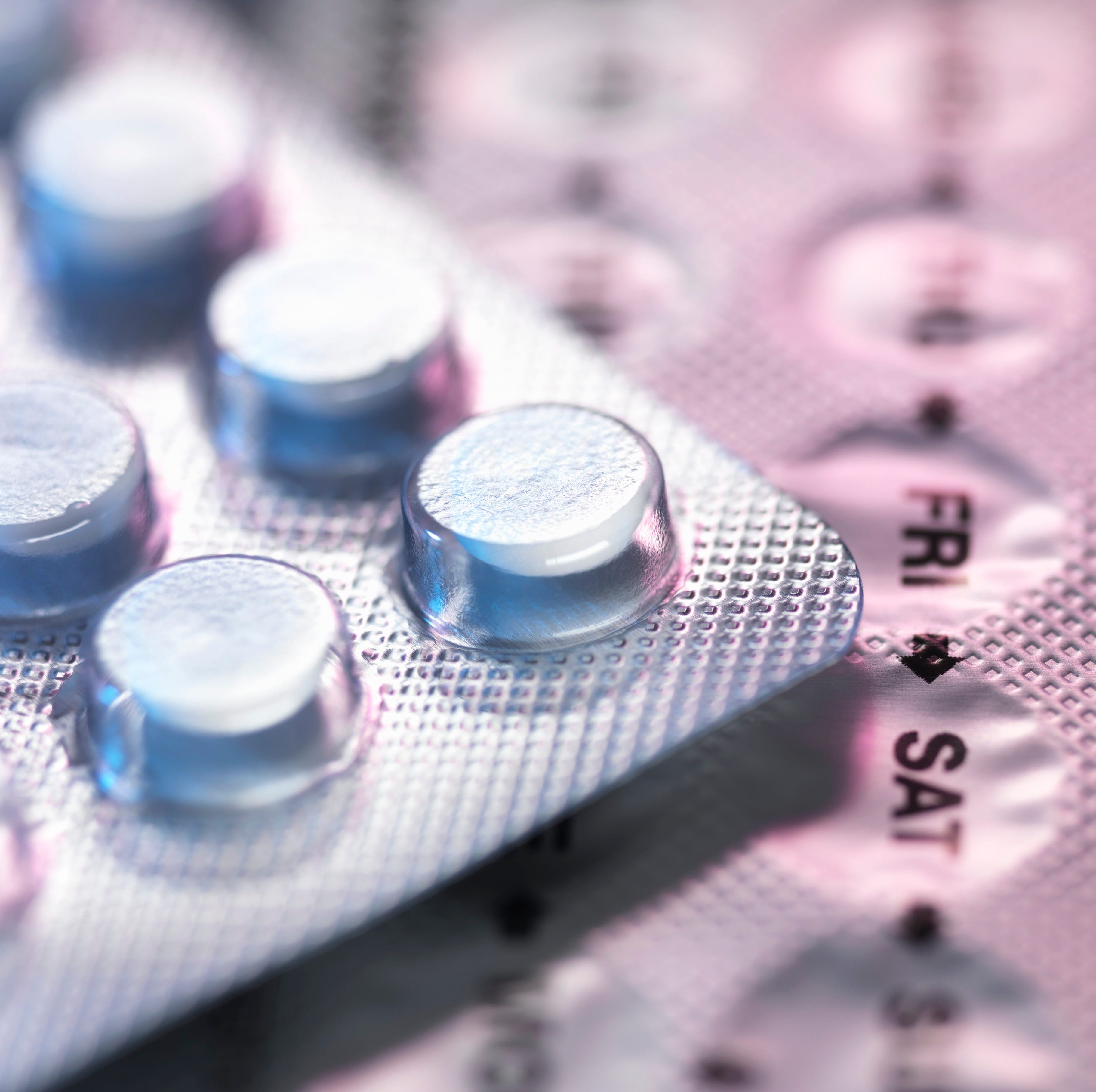 Extreme close up of birth control in its packets.
