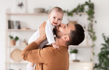 Father kissing his baby.