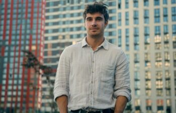 Caucasian man millennial thoughtful male looking away outdoors confident calm guy businessman look camera smile confidence handsome model boyfriend tourist on modern urban buildings background in city